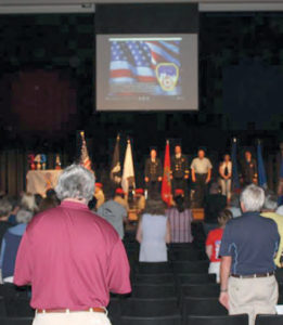 Audience participates in the Pledge of Allegiance.